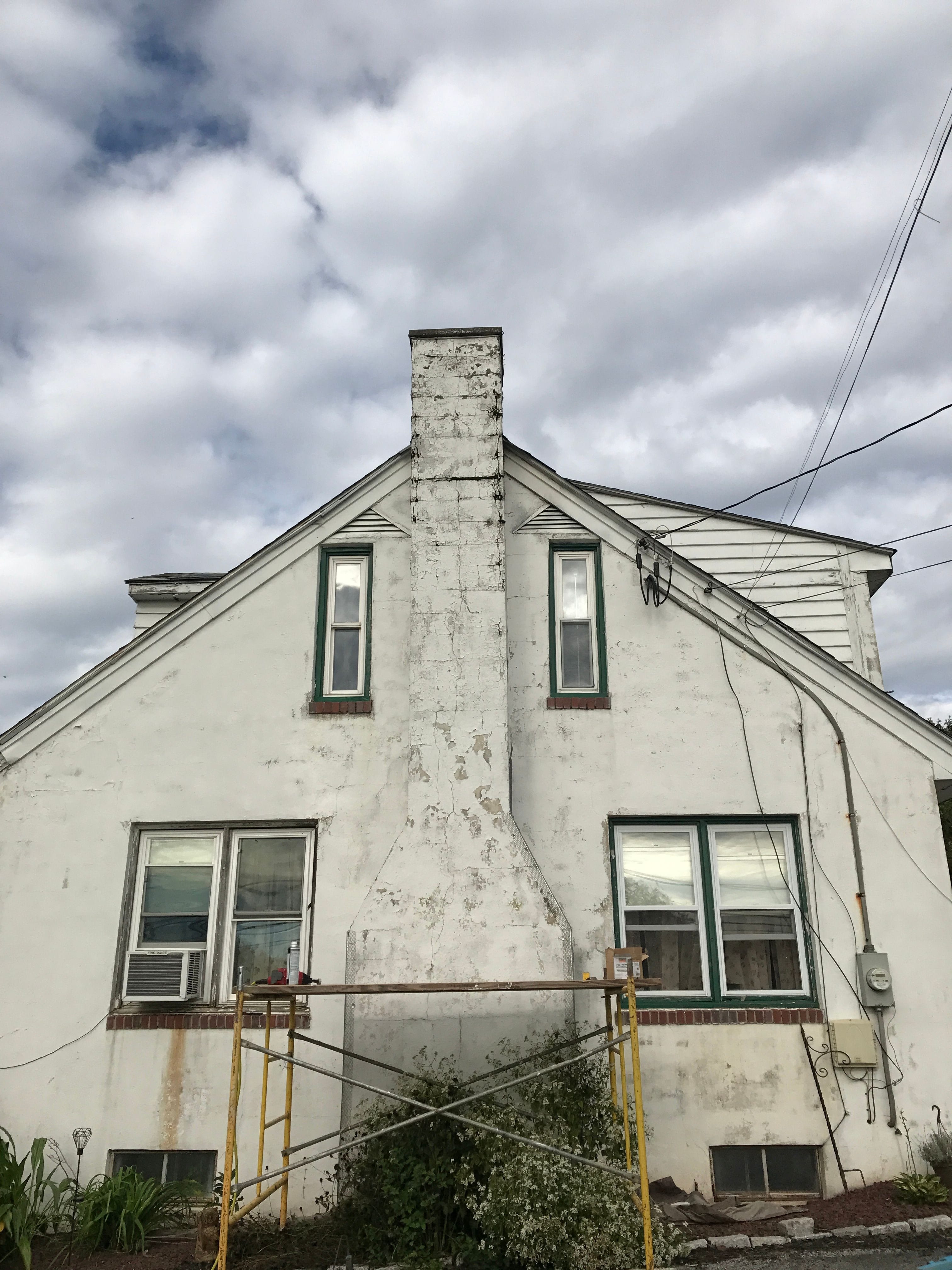 Newly applied Stucco Chimney with a Brick Ribbon Renovation on Farm House located West Caln Pennsylvania.
