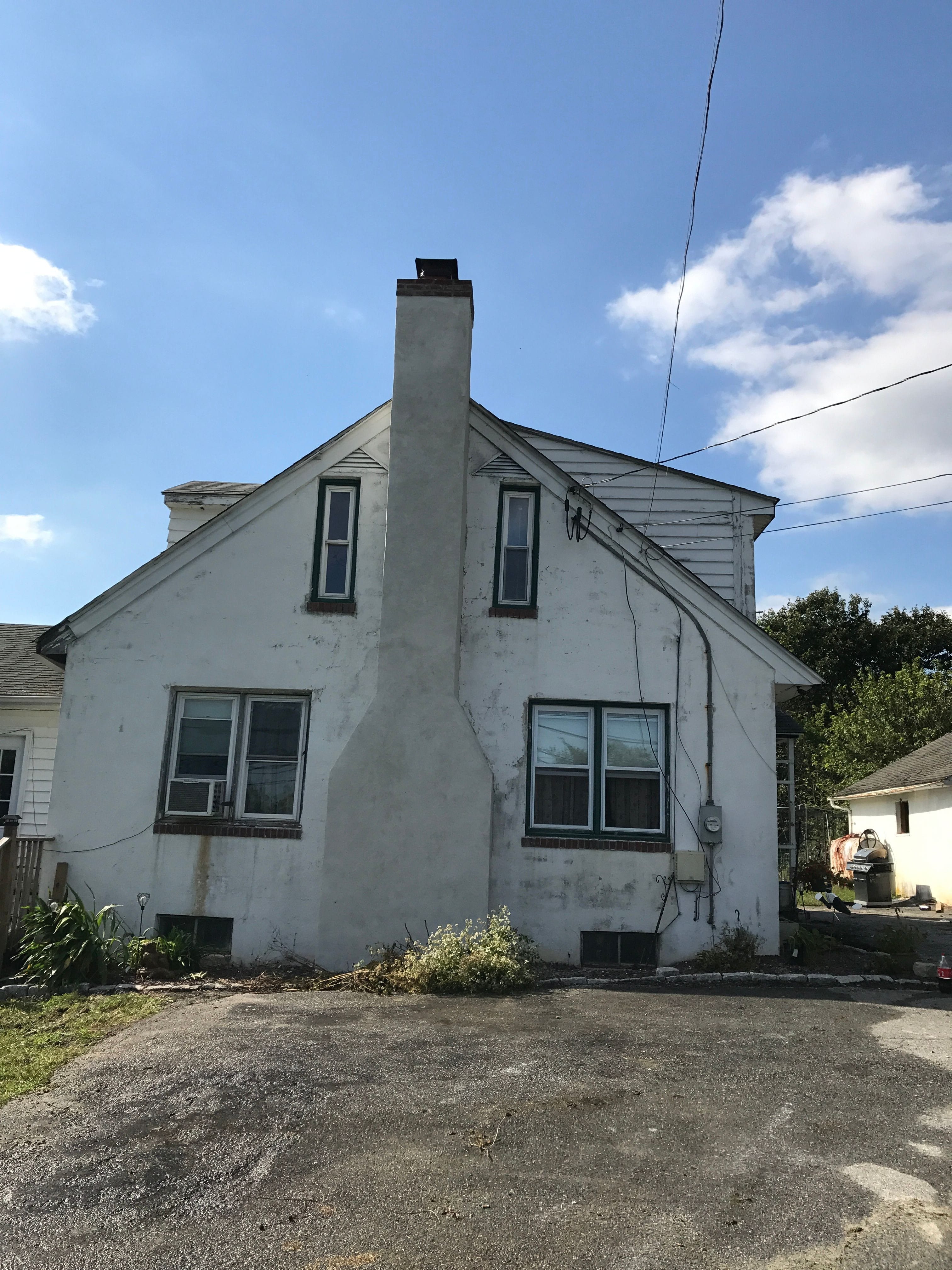 Newly applied Stucco Chimney with a Brick Ribbon Renovation on Farm House located West Caln Pennsylvania.
