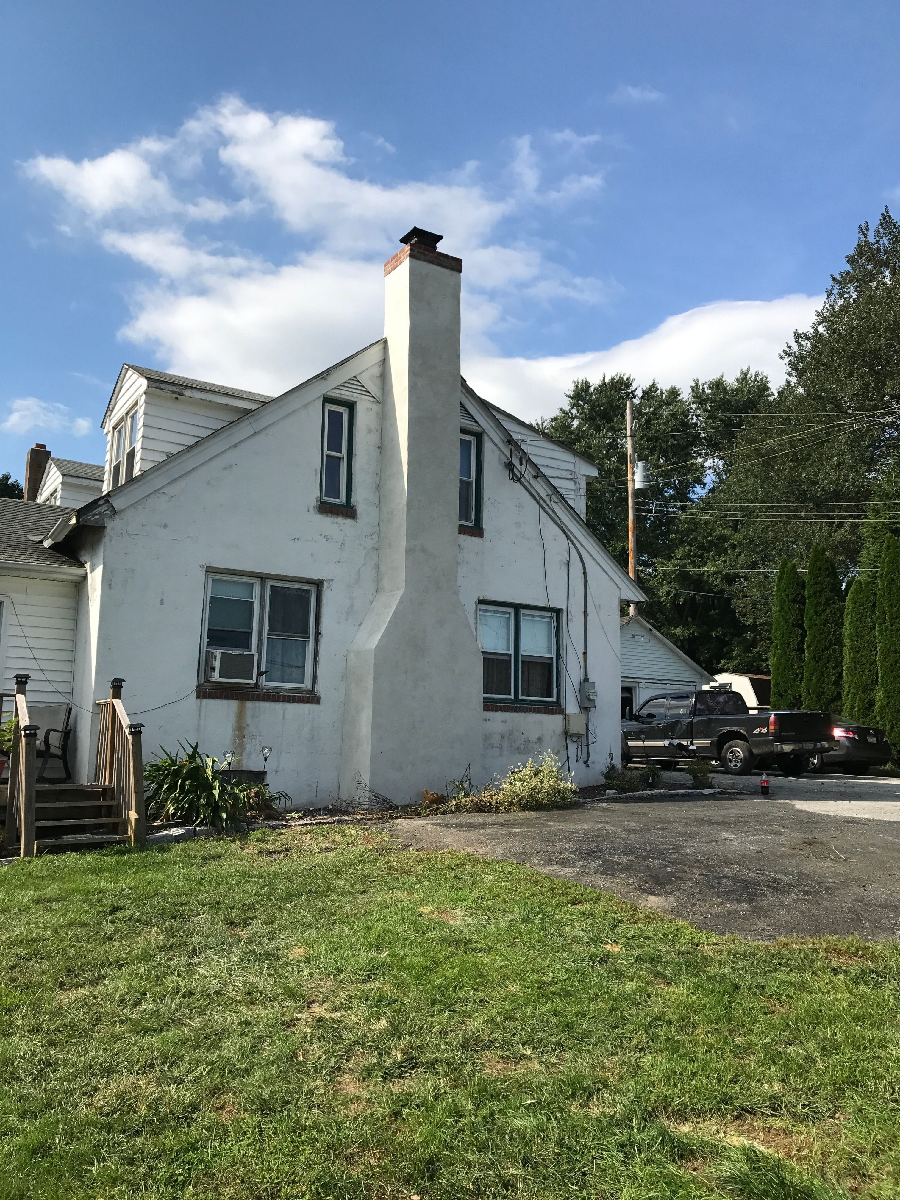 Newly applied Stucco Chimney with a Brick Ribbon Renovation on Farm House located West Caln Pennsylvania.,